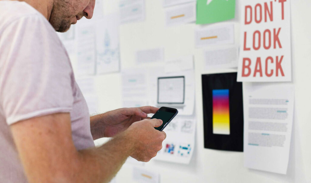 Product Owner standing in front of an inspiration wall for a mobile application