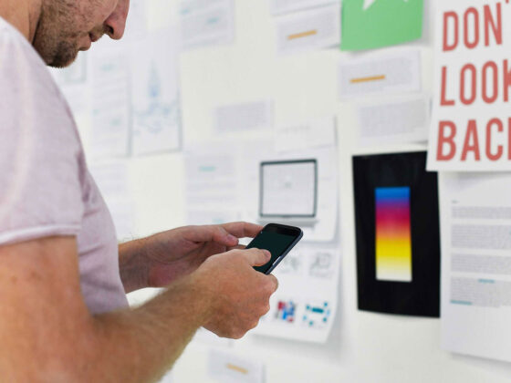 Product Owner standing in front of an inspiration wall for a mobile application