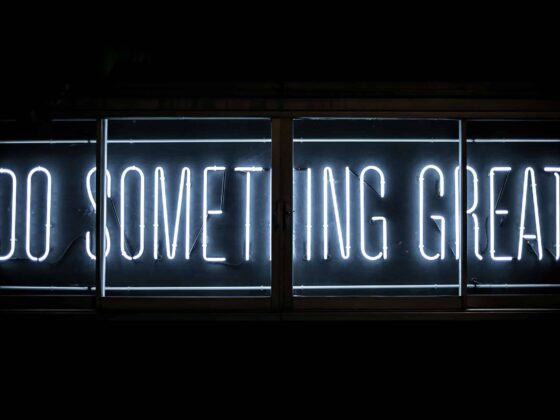 A fluorescent sign that reads "Do Something Great"