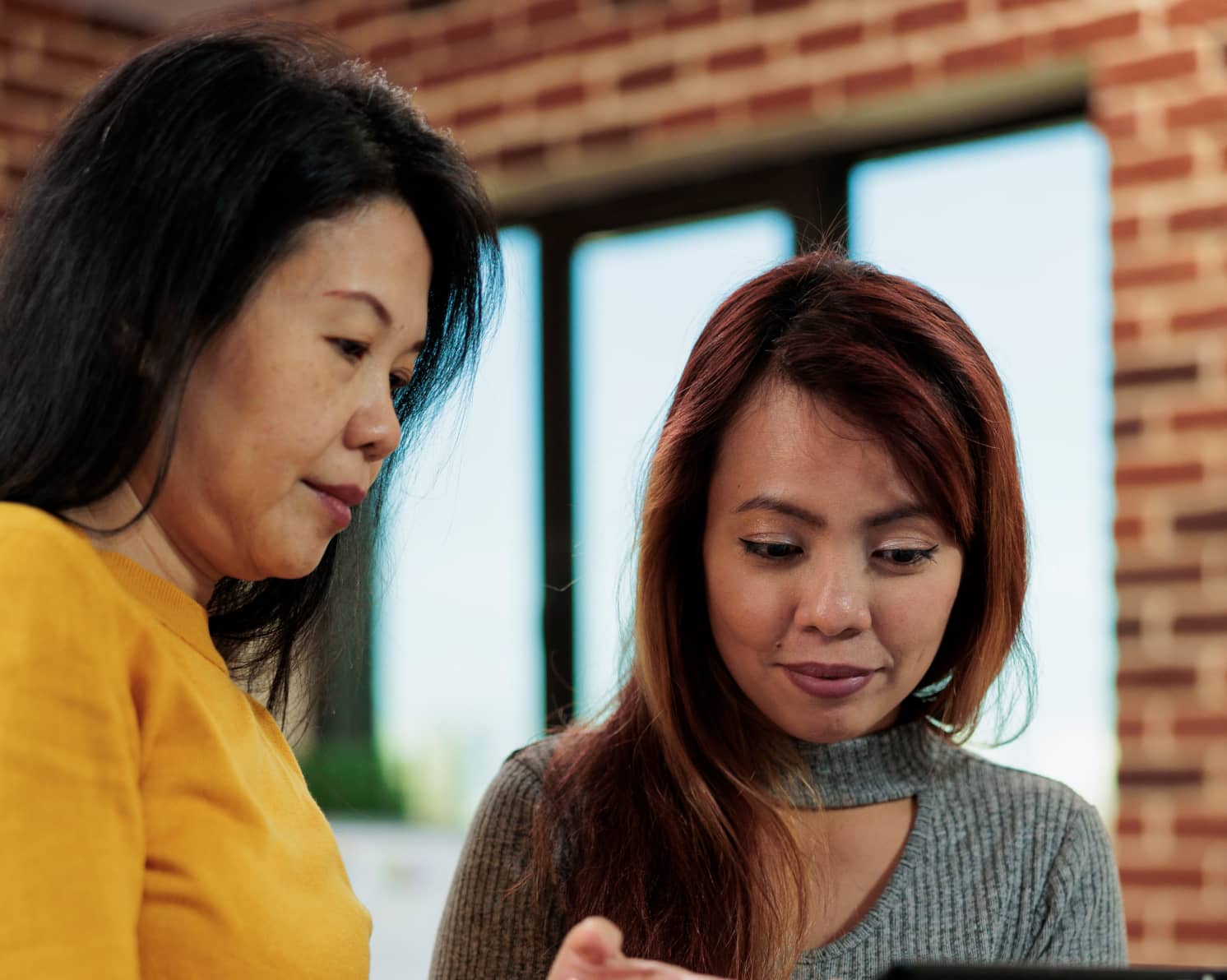 A picture of two female colleagues talking about an upcoming release