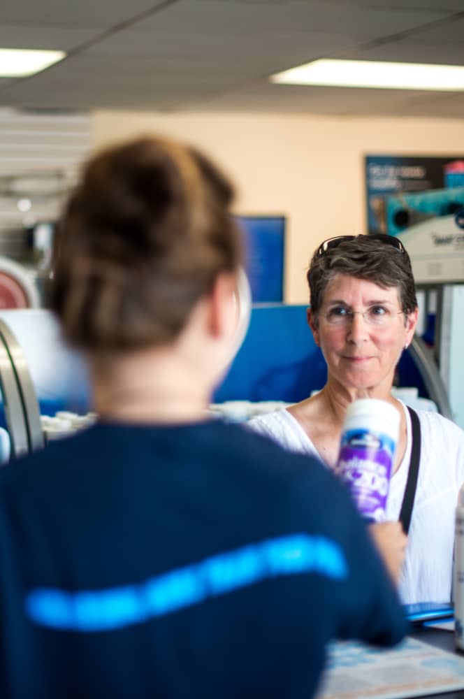 employee helping a customer in the store to purchase pool and spa chemicals