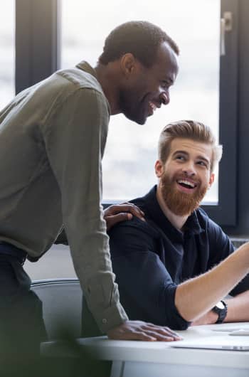 male coworkers discussing work at a table